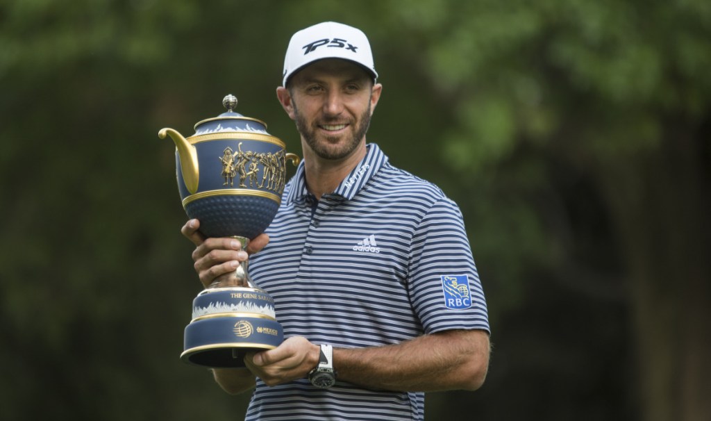 Dustin Johnson poses with his Mexico Championship trophy after winning the World Golf Championship event in Mexico City.