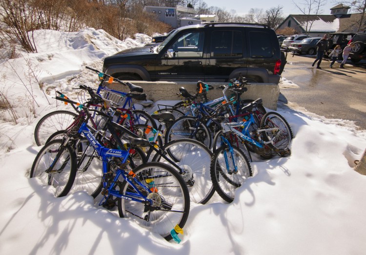 Apparently abandoned bicycles are stacked in the Peaks Island ferry parking lot Friday. Portland is gearing up to clamp down on abandoned bikes.