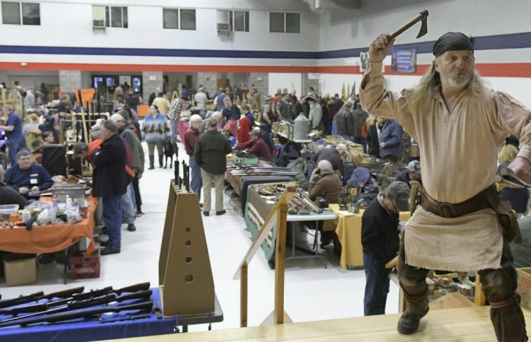 Ancient Ones of Maine member David Bryant of Mount Vernon hurls tomahawks Sunday during the group's gun show in Augusta. More than 1,800 people turned out.