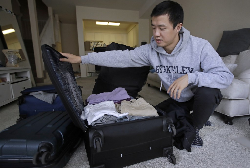 Leo Wang packs a suitcase at his home in San Jose, Calif. Wang has found himself trapped in an obstacle course regarding H-1B work visas for foreigners. His visa denied and his days in the United States numbered, Wang is looking for work outside the country. "I still believe in the American dream," he says.