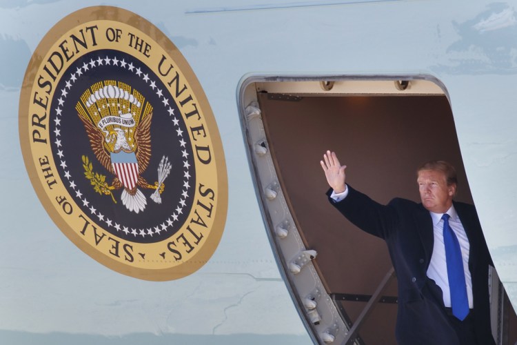 President Trump waves as he boards Air Force One Monday at Andrews Air Force Base in Maryland en route to Hanoi, Vietnam.