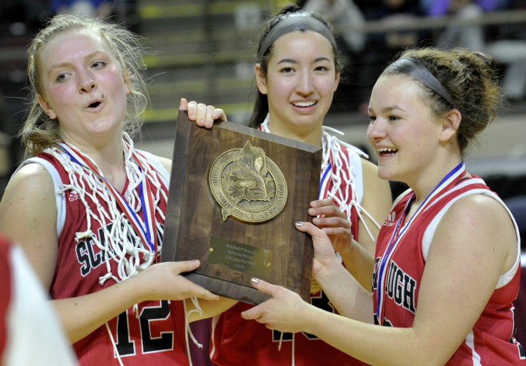 Madison Blanche, center, celebrates with teammates Josie Couture, left, and Leah Dickman after Scarborough won the Class AA South title on Friday. Blanche scored 16 points, taking Coach Mike Giordono's direction to look for her shot – and take it – more often.