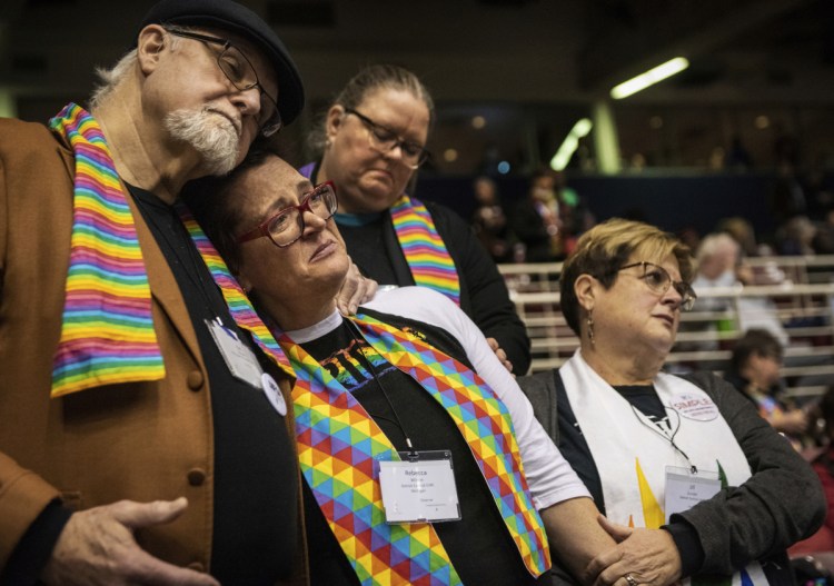 Ed Rowe, left, Rebecca Wilson, Robin Hager and Jill Zundel react to the defeat of a proposal that would allow LGBT clergy and same-sex marriage within the United Methodist Church, at the denomination's 2019 Special Session of the General Conference in St. Louis, Mo., on Tuesday.