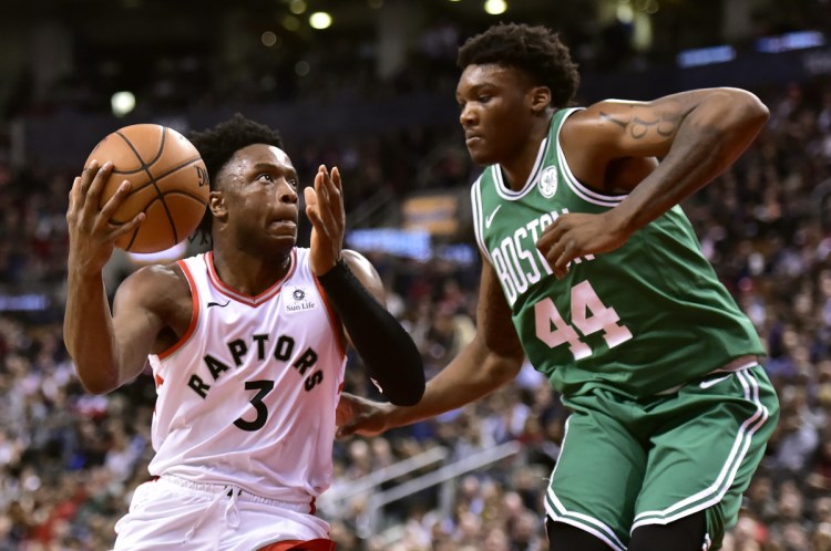 Boston Celtics center Robert Williams defends as Toronto Raptors forward OG Anunoby looks for the shot during second half of the Celtics' 118-95 loss on Tuesday in Toronto.