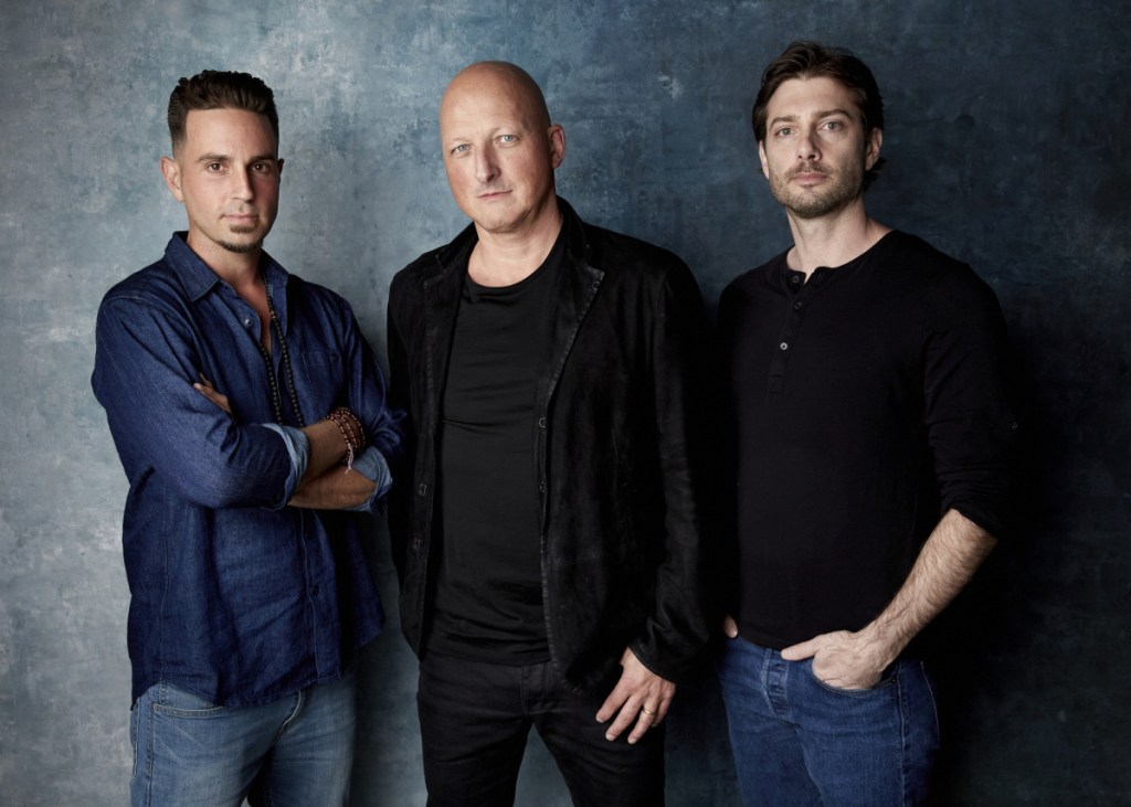 Wade Robson, from left, director Dan Reed and James Safechuck pose for a portrait to promote the film "Leaving Neverland" during the Sundance Film Festival in Park City, Utah. The documentary, which premiered at the festival to a standing ovation, will begin airing on HBO on Sunday.