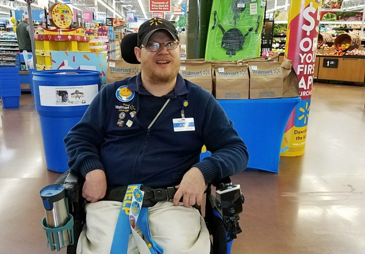 Greeter John Combs works at a Walmart store April 21 in Vancouver, Wash. Combs, who has cerebral palsy, and other greeters with disabilities are threatened with job loss as Walmart transforms the greeter position into one that's more physically demanding. Combs was devastated and then angered by his impending job loss.
