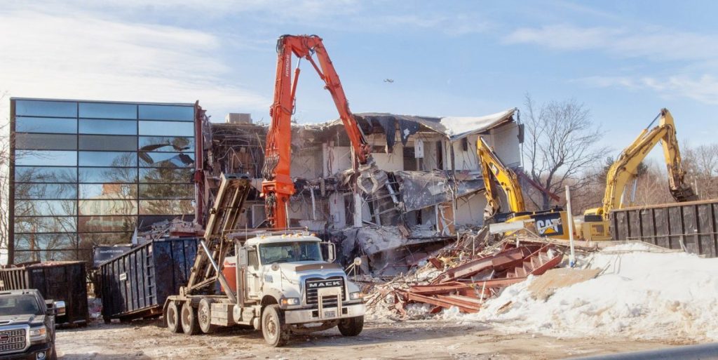 Excavators tear apart the old Maine Public Employees Retirement System building on Wednesday at the corner of Sewall and Capitol streets near the Maine State House in Augusta.