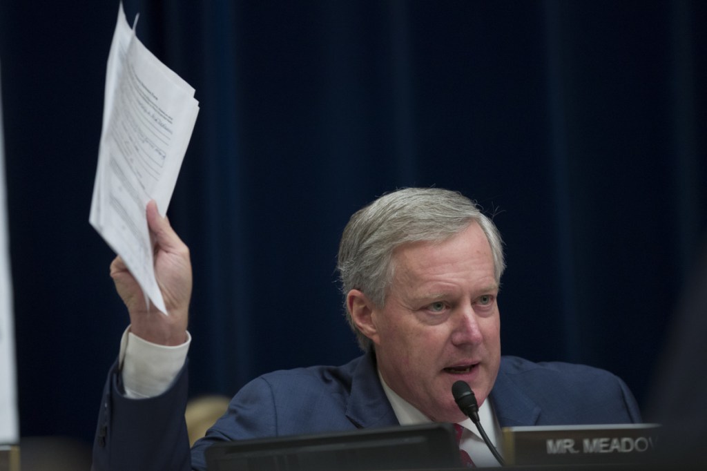 Rep. Mark Meadows, R-N.C., holds up documents as he questions Michael Cohen, President Trump's former lawyer, as Cohen testifies Wednesday before the House Oversight and Reform Committee in Washington.