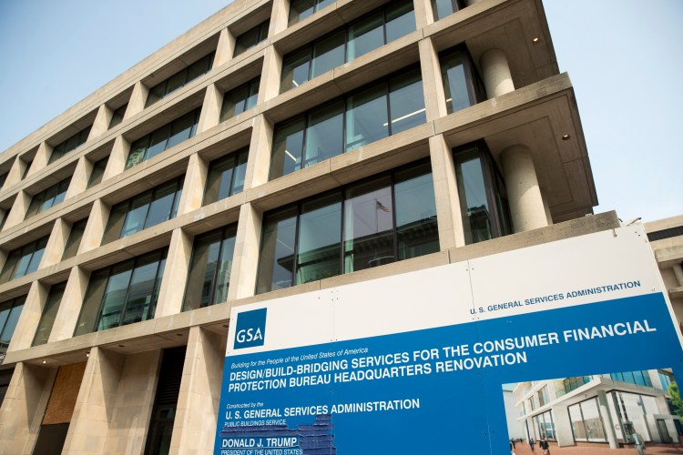 In this Aug. 27, 2018, file photo a sign stands at the construction site for the Consumer Financial Protection Bureau's new headquarters in Washington. The nation's federal financial watchdog has announced its plans to roll back most of its consumer protections governing the payday lending industry. It's the Consumer Financial Protection Bureau's first rollback of regulations under its new Director, Kathy Kraninger, who took over the bureau late last year. 