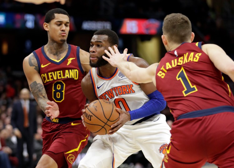 New York Knicks' Kadeem Allen drives between Cleveland Cavaliers' Jordan Clarkson, left, and Cleveland Cavaliers' Nik Stauskas in the second half Monday in Cleveland. The Knicks lost their 17th straight game.