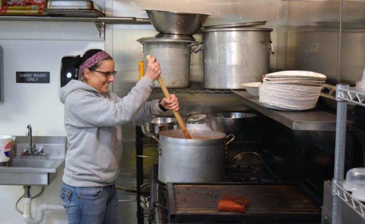 Mary Graziano Richard stirs a pot of sauce in preparation for the days orders at her new business Grazi to Go. Richard is serving up some of the favorites from Graziano’s Casa Mia Restaurant in Lisbon.