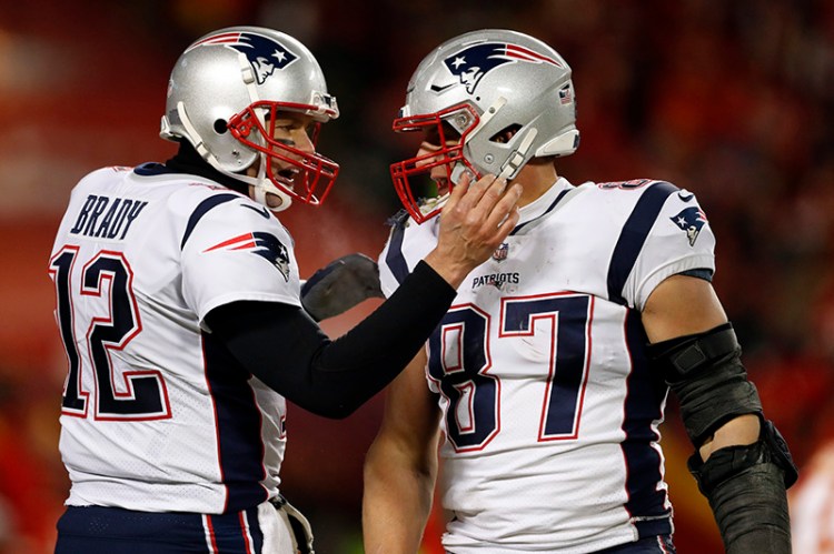 New England Patriots quarterback Tom Brady (12) celebrates with tight end Rob Gronkowski (87) during the second half of the AFC Championship NFL football game against the Kansas City Chiefs.