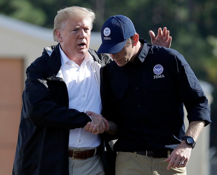 President Donald Trump shakes hands with FEMA Administrator Brock Long after visiting areas in North Carolina and South Carolina impacted by Hurricane Florence at Myrtle Beach International Airport in Myrtle Beach, S.C. in 2018.