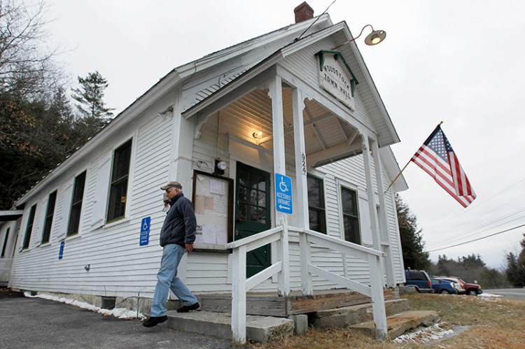 A voter exits the Woodstock Town Hall in New Hampshire in 2012.