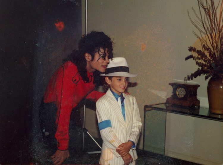Michael Jackson poses for a photo with a young Wade Robson. 