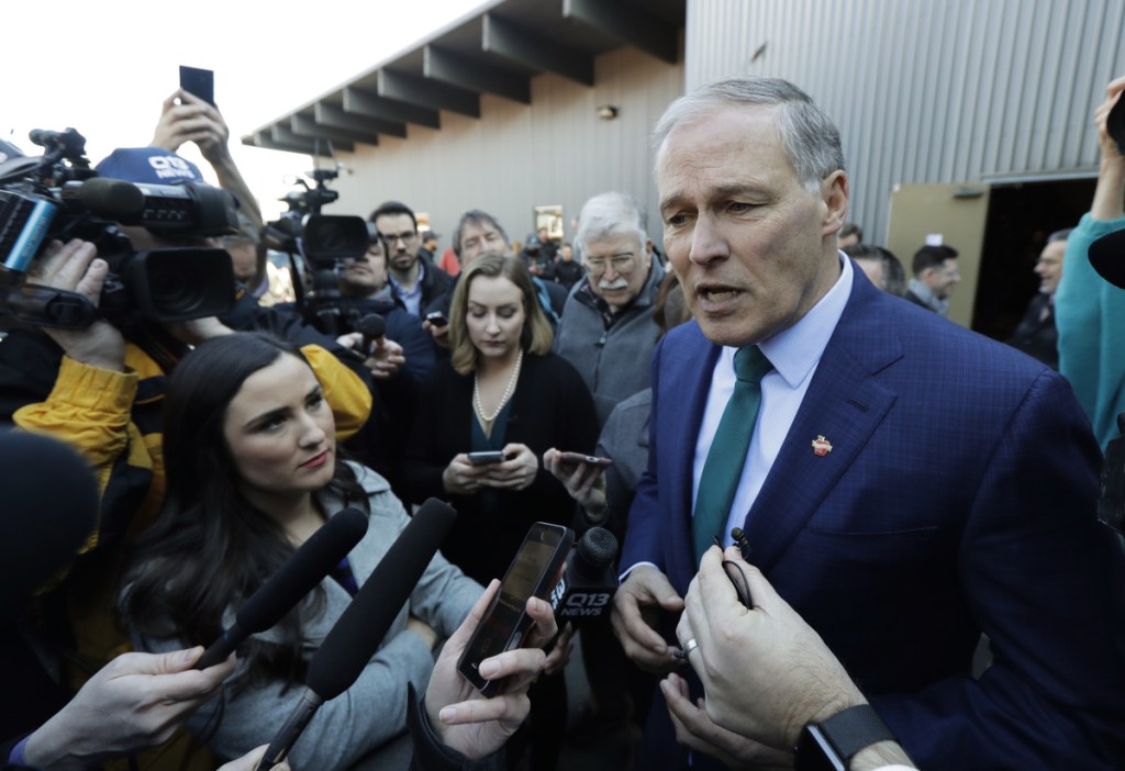 Washington Gov. Jay Inslee answers questions from reporters Friday after speaking at a campaign event at A&R Solar in Seattle. Inslee announced that he will seek the 2020 Democratic presidential nomination, mixing calls for combating climate change and highlights of his liberal record with an aggressive critique of President Trump.