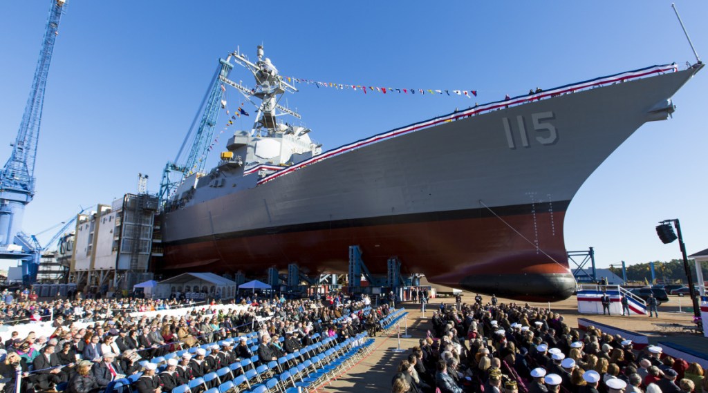 The audience is assembled for the christening ceremony of the USS Rafael Peralta at Bath Iron Works.