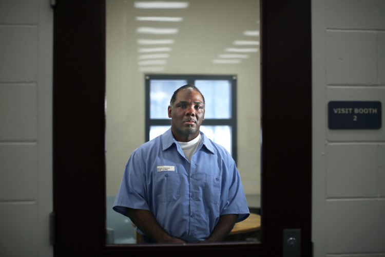 Foster Bates poses for a portrait last month in a visiting room at the Maine State Prison in Warren. Bates has been serving a life sentence since he was convicted in 2002 of raping and murdering a South Portland woman. He has maintained his innocence from the start and has been pushing for a new trial.