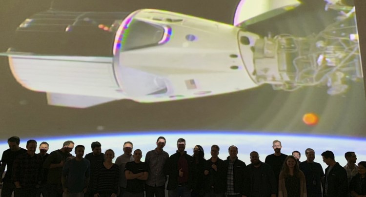 The SpaceX team in Hawthorne, Calif., watches as the Dragon capsule docks with the International Space Station on Sunday.