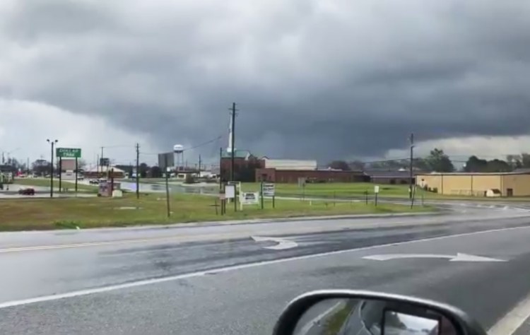 A funnel cloud looms over Byron, Ga., on Sunday as a line of severe storms sweeps into the region. In Beauregard, Ala., rescue teams were searching for survivors after a suspected tornado killed 14 people.
Greg Martin via AP