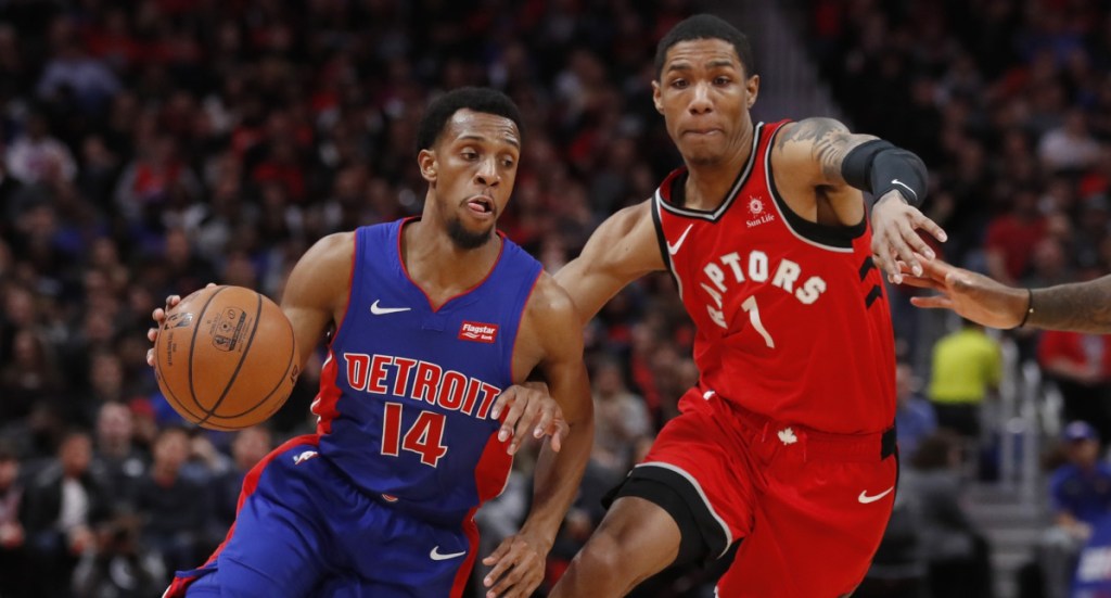 Ish Smith of the Detroit Pistons looks for room to drive Sunday night against Patrick McCaw of the Toronto Raptors during the first half of Detroit's 112-107 overtime victory.