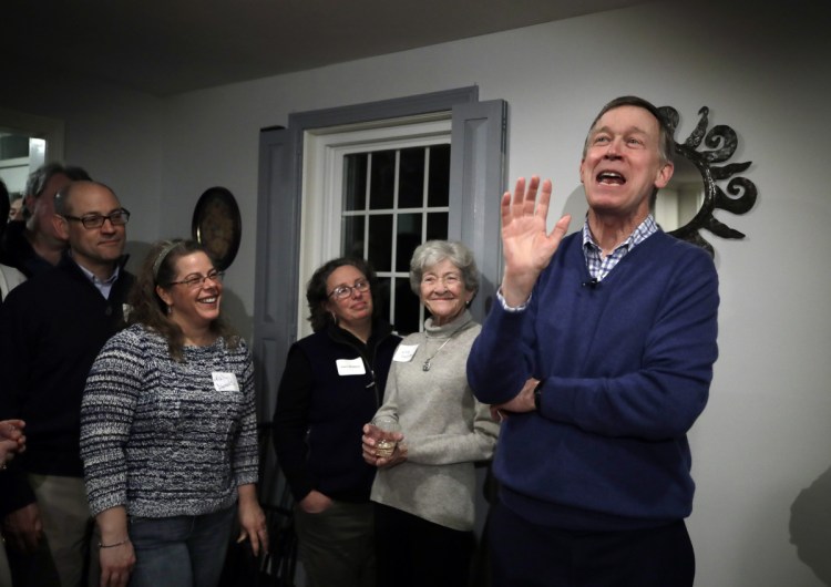 Former Colorado Gov. John Hickenlooper speaks at a campaign house party in Manchester, N.H.