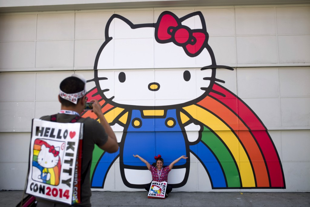 Keith Nunez, left, takes pictures of his wife, Carolina, at the first-ever Hello Kitty fan convention, Hello Kitty Con, at the Geffen Contemporary at MOCA in Los Angeles in 2014. (Associated Press/Jae C. Hong)