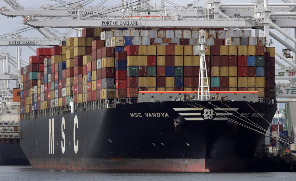 A container ship is unloaded at the Port of Oakland in Oakland, Calif., in January. The U.S. trade deficit continues to hit record highs despite President Trump's intervention through tariffs.