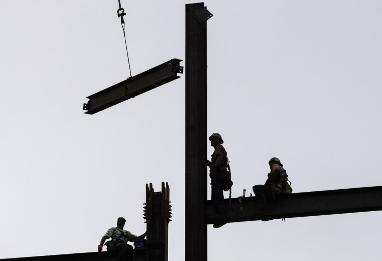 Ironworkers construct a commercial and residential building in Philadelphia in June 2018.