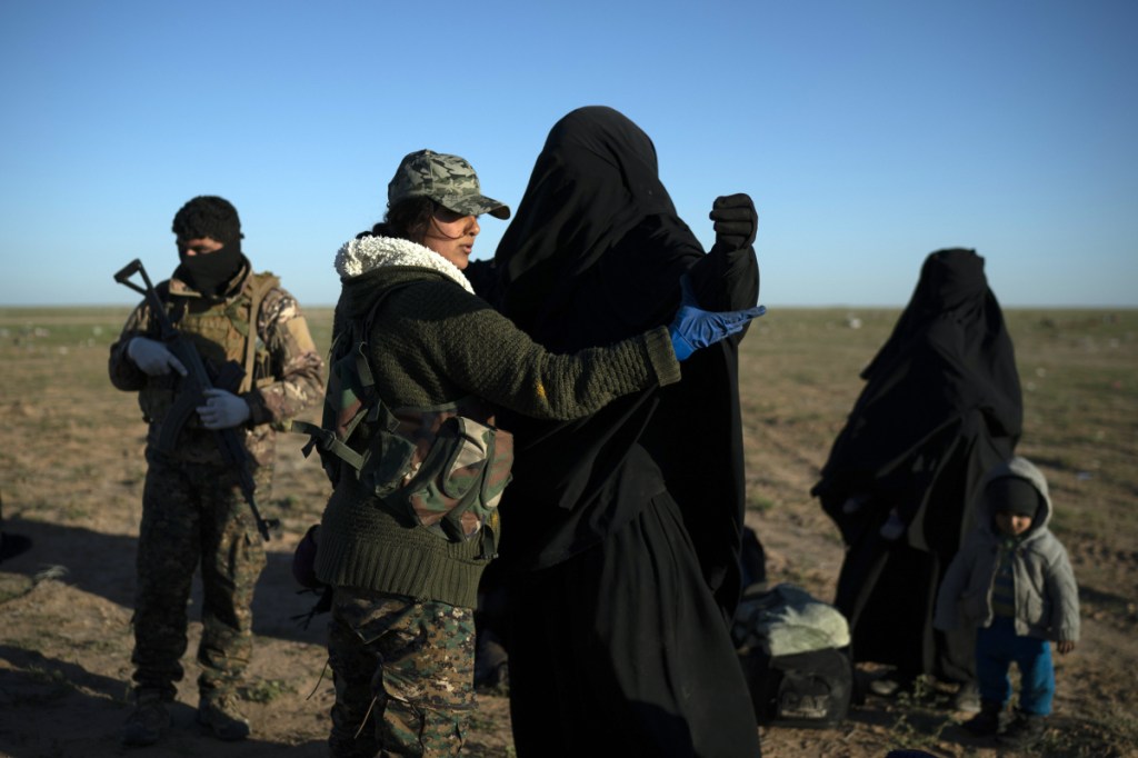 A woman who was evacuated from Islamic State's last redoubt near Baghouz, Syria, is searched by a Syrian Democratic Forces fighter at a screening area on Friday.