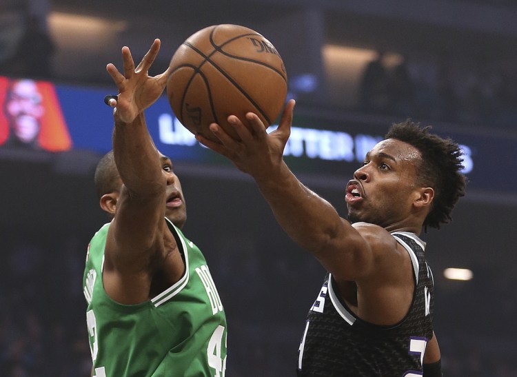 Sacramento Kings guard Buddy Hield goes to the basket against Celtics center Al Horford in the first quarter of Wednesday night's game in Sacramento. The Celtics went on to win, improving to 2-0 on their road trip.