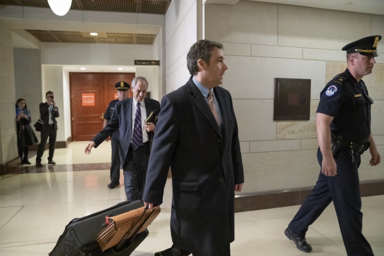 Michael Cohen, President Donald Trump's former lawyer, departs following a full day of testimony with the House Intelligence Committee behind closed doors as he prepares for a three-year prison sentence for lying to Congress and other charges, at the Capitol in Washington, Wednesday, March 6, 2019. Cohen told reporters he will "continue to cooperate" with investigators. (AP Photo/J. Scott Applewhite)