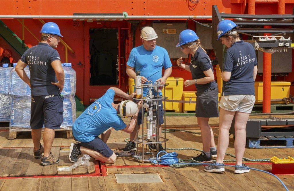 Researchers prepare to launch a water measurement device as the British-led Nekton Mission begins in the tiny Alphonse atoll in the Seychelles on Thursday.