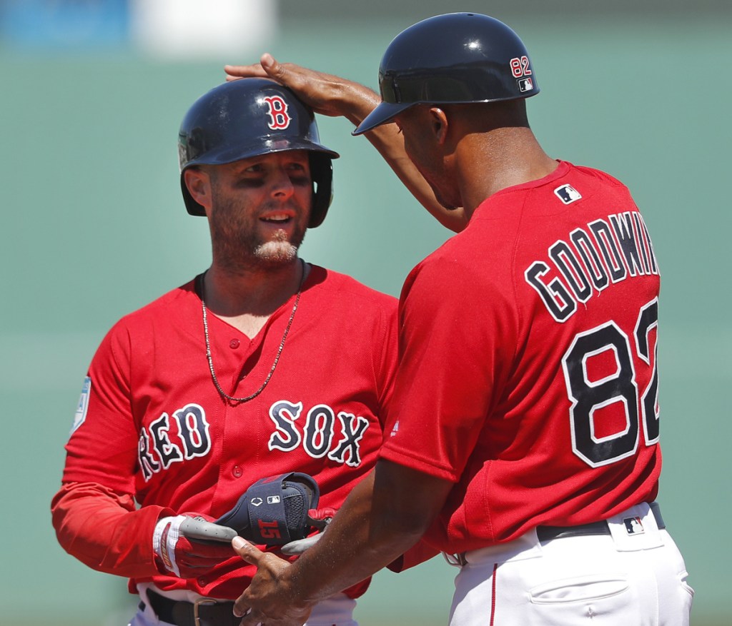 Dustin Pedroia is congratulated by Red Sox first-base coach Tom Goodwin after hitting a single in the first inning Thursday against the Minnesota Twins.