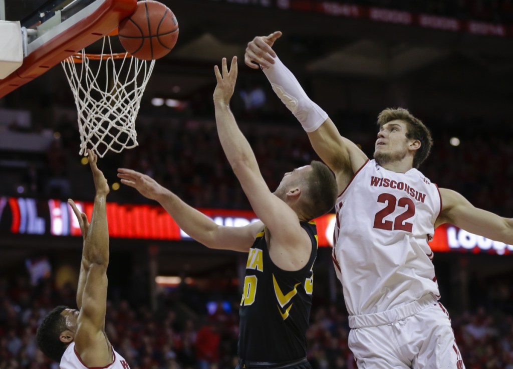 Wisconsin's Ethan Happ, right, blocks a shot by Iowa's Connor McCaffery during Wisconsin's 65-45 win Thursday night.
