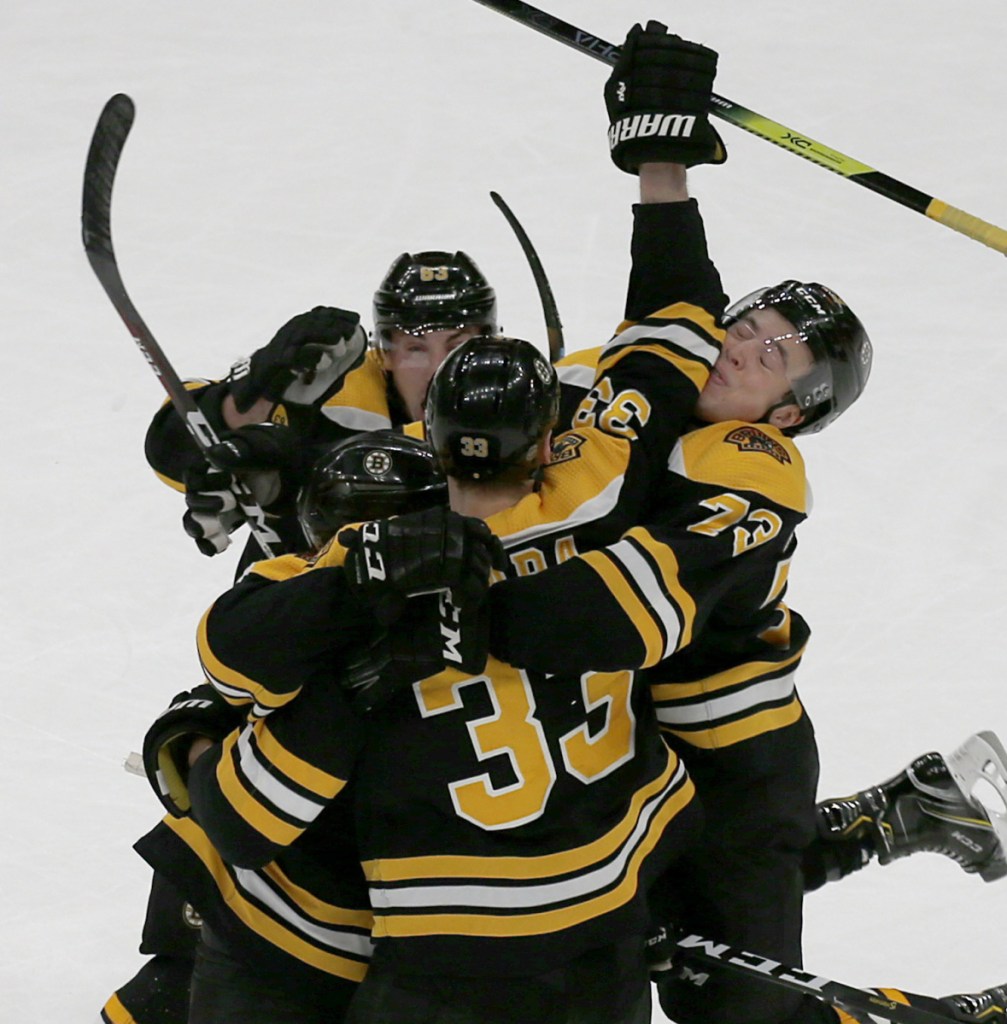 Bruins players crowd around Patrice Bergeron after his goal with 7.2 seconds left gave Boston a 4-3 win Thursday against the Florida Panthers.