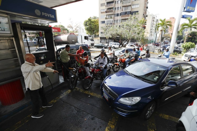 Customers line up at a gas station Friday in Caracas, Venezuela. Much of Venezuela was still without electricity Friday amid the country's worst-ever power outage, raising tensions in a nation already on edge from ongoing political turmoil.