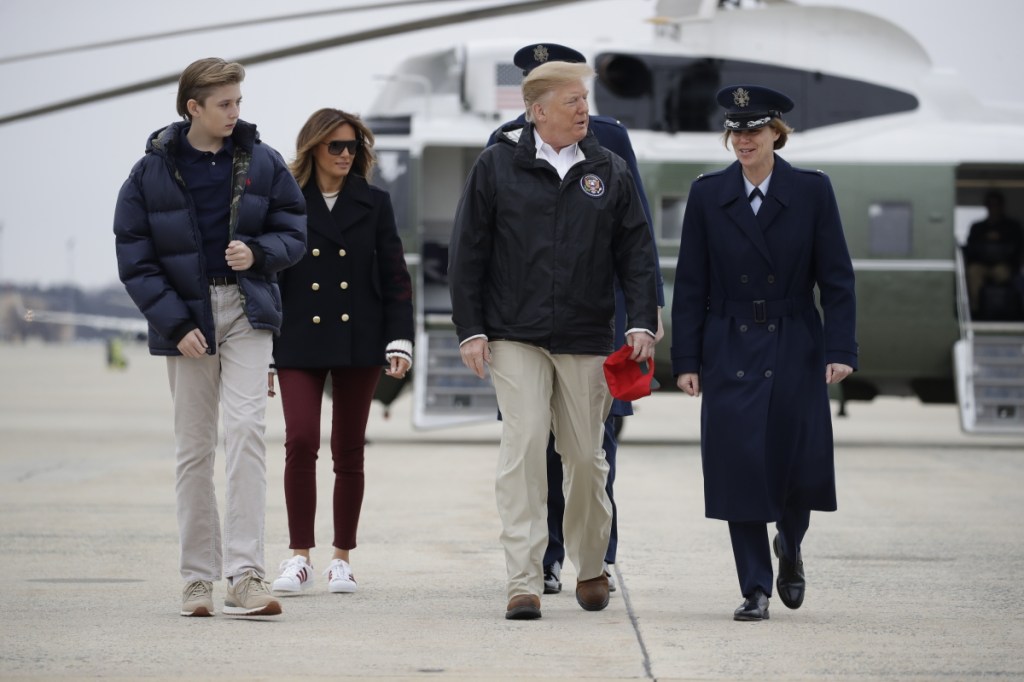 President Trump, first lady Melania Trump and their son Barron walk to board Air Force One on Friday at Andrews Air Force Base, Md. They were en route to Lee County, Ala., where tornadoes killed 23 people and caused widespread damage last Sunday.