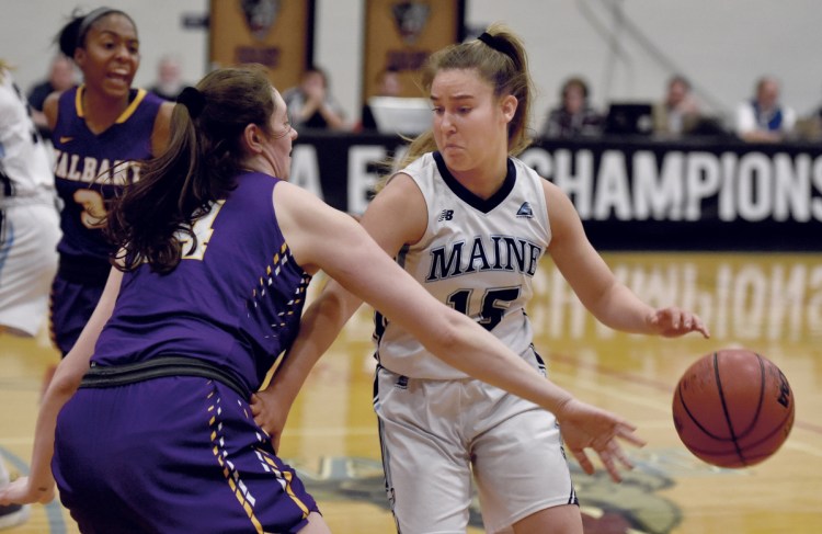 UMaine's Dor Saar is pressured by Albany's Alexi Schecter during their America East semifinal game on Sunday in Orono. The Black Bears won 66-51 to advance to the tournament championship game.