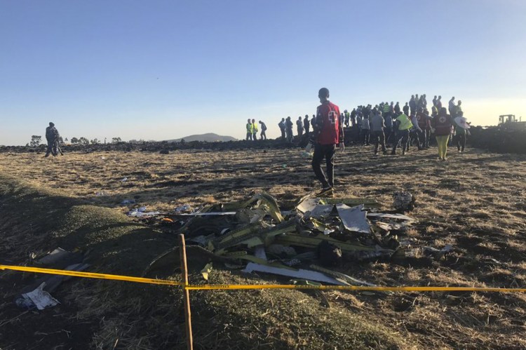 Rescuers search at the scene of an Ethiopian Airlines flight that crashed shortly after takeoff at the scene at Hejere near Bishoftu, or Debre Zeit, some 31 miles south of Addis Ababa Sunday.