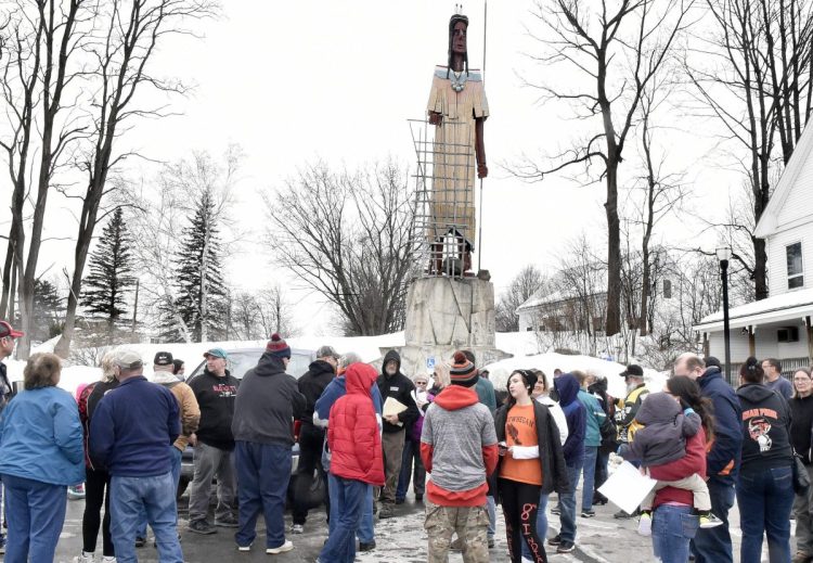 Local residents assemble Sunday below the sculpture of an Indian in Skowhegan to sign a petition to overturn the recent SAD 54 school board decision to stop using the "Indian" nickname for school teams.