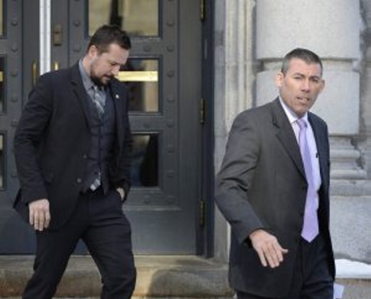 Federal Deportation Officer Elliot Arsenault, left, and Maine State Trooper Robert Burke III leave U.S. District Court in Portland, after motions were heard in an immigration case.