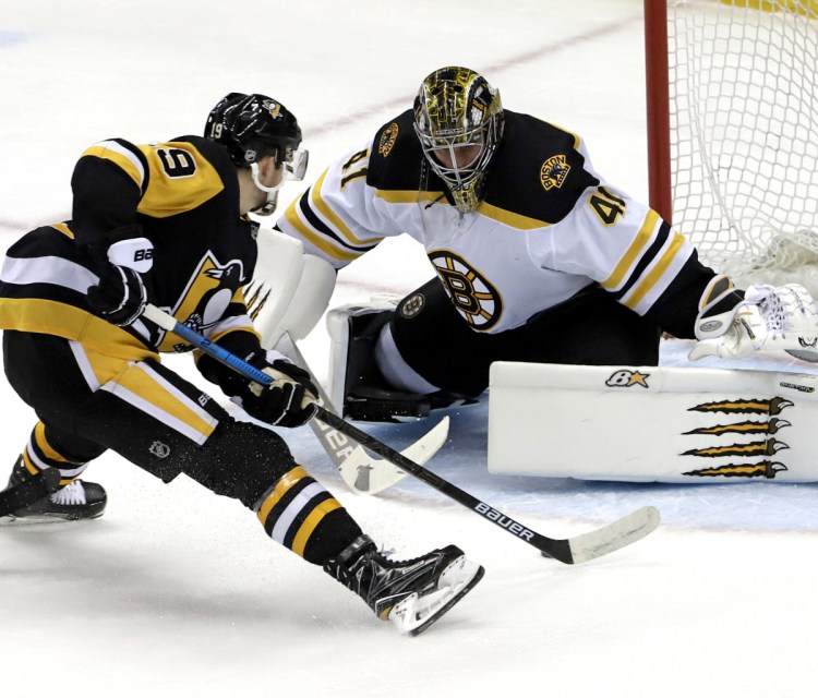 Jared McCann of the Penguins moves in against Bruins goalie Jaroslav Halak as he scores a short-handed goal during Pittsburgh's 4-2 win Sunday night.