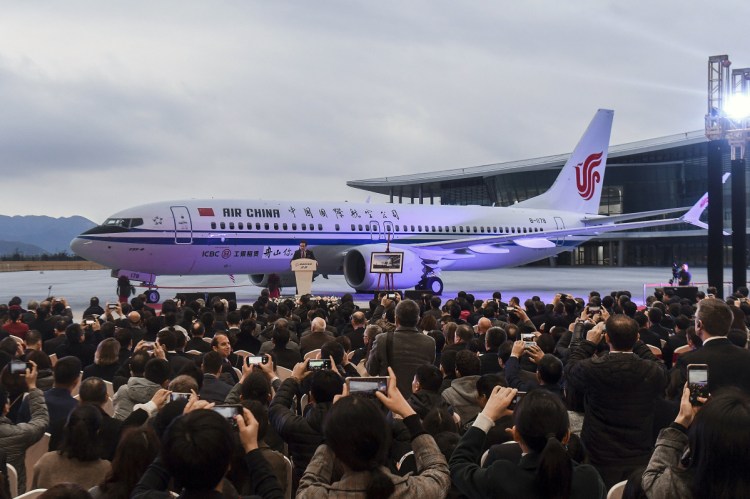 Invited guests take photos of the Boeing 737 Max 8 airplane delivered to Air China during a ceremony in December in Zhoushan. China's civilian aviation authority on Monday ordered all Chinese airlines to ground their Boeing 737 after one of the aircraft crashed in Ethiopia.