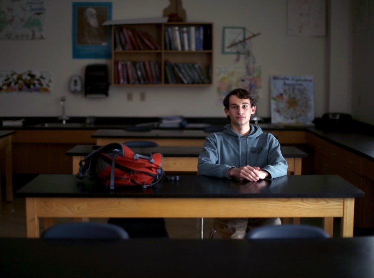 Matt Hogenauer poses for a portrait in a biology classroom at Falmouth High School. Hogenauer takes arthritis medication that suppresses his immune system and makes him vulnerable to infectious diseases. He strongly supports a bill that would eliminate all non-medical exemptions for school-required vaccines.