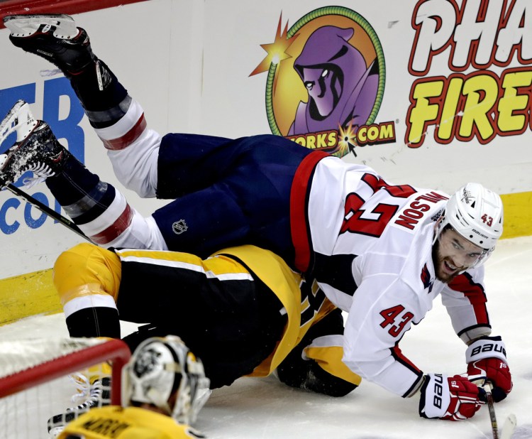 Tom Wilson of the Capitals collides with Pittsburgh's Marcus Pettersson in the first period Tuesday at Pittsburgh. The Penguins won 5-3, ending the Caps' seven-game winning streak.