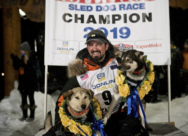 Peter Kaiser poses with his lead dogs, Morrow, left, and Lucy, on Wednesday in Nome, Alaska, after winning the Iditarod Trail Sled Dog Race. It's the first Iditarod victory for Kaiser in his 10th attempt.