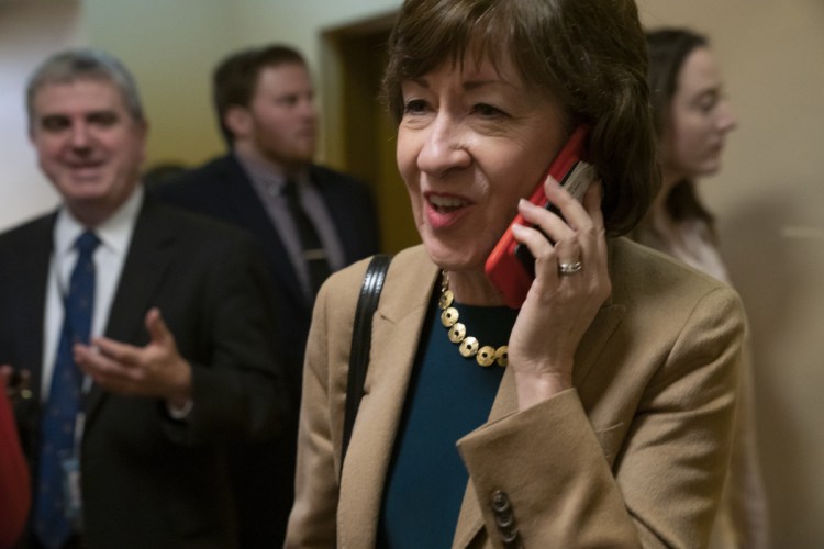 Sen. Susan Collins, R-Maine, arrives in the Senate where she has said she will vote for a resolution to annul President Trump's declaration of a national emergency at the southwest border, on Capitol Hill in Washington on Thursday.