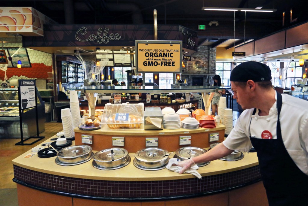 An employee wipes down the soup bar at a store in Boulder, Colo., that promotes and sells organic products. The Cornucopia Institute, a farm policy research group, says it has found significant variation in what is designated as organic.