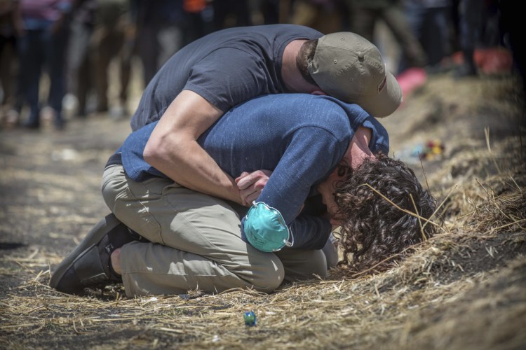 Grieving relatives break down while visiting the crash site of the Ethiopian Airlines Boeing 737 Max 8 that went down on Sunday, killing all 157 on board south of Addis Ababa.